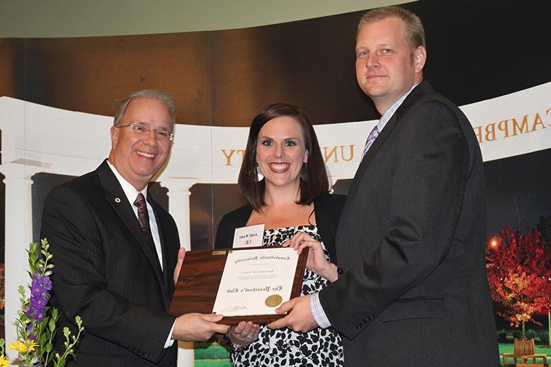 From left, Ryan and Ashli Watts of Frankfort, Ky. receive a plaque from CU President Dr. Michael V. Carter for their induction into the President's Club. (Campbellsville University Photo by Drew Tucker)