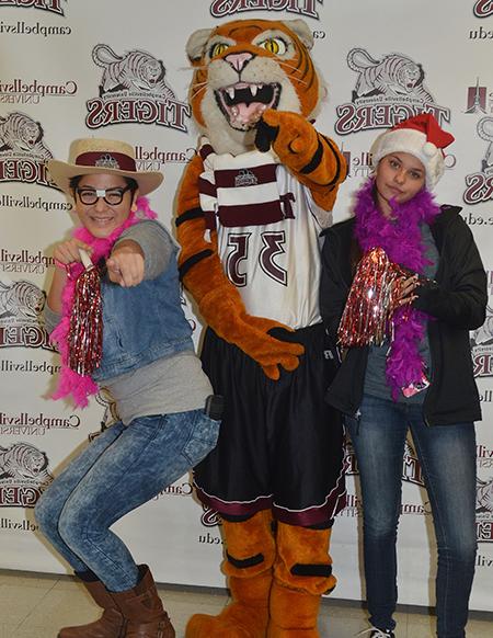 CHS seniors Brooklyn Harris, at left, and Belen Garcia, at right, pose for a photo with Clawz.