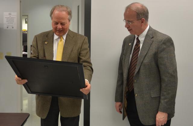 U.S. Congressman Ed Whitfield, right, (R-Ky.) looks at a new Campbellsville University academic/athletic poster given to him by Dr. Michael V. Carter, president of CU, left. (Campbellsville University Photo by Joan C. McKinney)