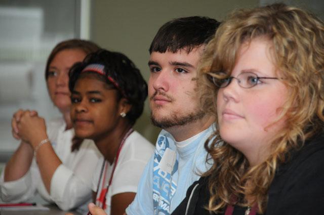 Incoming freshmen listen to announcements before lunch during the Welcome Weekend Extravaganza. Pictured from left are: Katherine Lee from Owensboro, Ky.; Andrew McGinnis from Waynesburg, Ky.; Alexis Hester from Louisville, Ky.; and Dr. Michelle Tucker, assistant professor of social work at CU. (Campbellsville University Photo by André Tomaz)