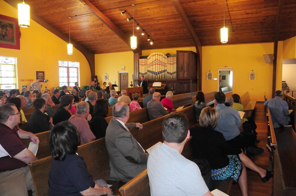 Doug Tucker, OLPH music director, gives a brief history on the organ and thanks several people for helping make it a part of the church. (Campbellsville University Photo by Drew Tucker)