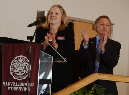 Dr. Frank Cheatham, left, and Dr. Donna Hedgepath applaud the  award recipients. (Campbellsville University Photo by Linda  Waggener)