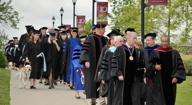 Dr. Joseph Owens, left, chair of the CU Board of Trustees, and Dr. Michael V. Carter, president of Campbellsville University, lead graduate students to commencement. (Campbellsville University Photo by Linda Waggener)