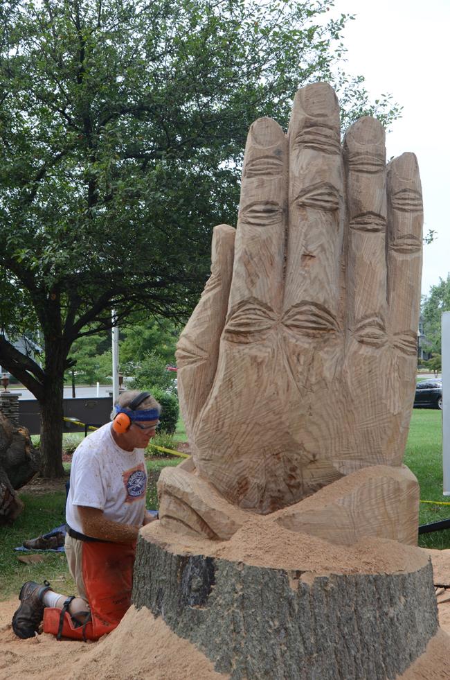 Rob Peterson, a Louisville artist, continues work Monday on the praying hands he has designed on Stapp Lawn. He is an independent worker and a full-time remodeler and builder. Peterson does his own designs, but he uses photos and others' ideas to inspire his work. (Campbellsville University Photo by Kyle Perkins)