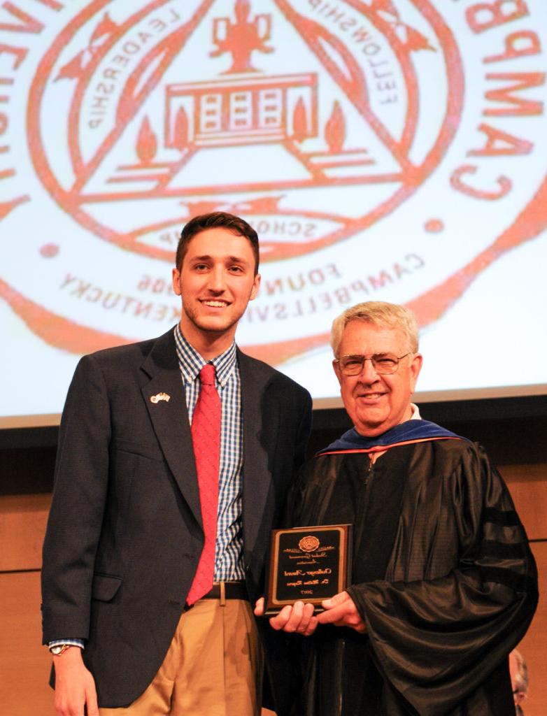 Dr. Milton Rogers, left, professor of biology at Campbellsville University, receives the Challenger Award from Aaron Nosich, president of the Student Government Association at Campbellsville University. (Campbellsville University Photo by Joshua Williams)