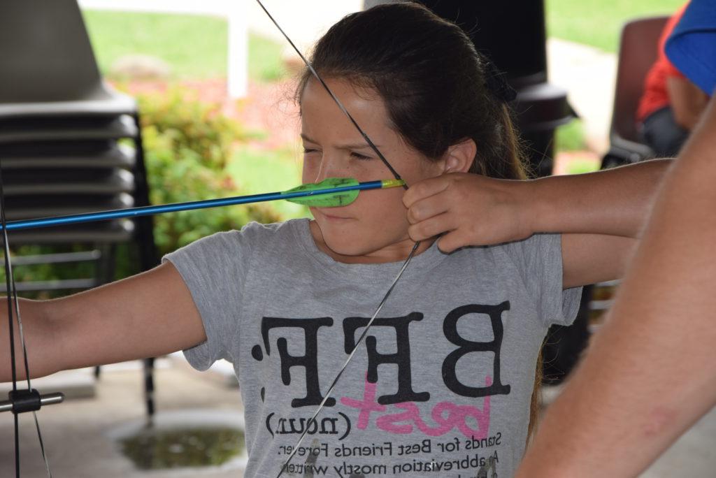 During the Archery class, offered by the Kids College on Campbellsville University's campus, Keira Gadberry of Liberty, Ky. focuses on her target before she releases.  (Campbellsville University Photo by Ariel Emberton)