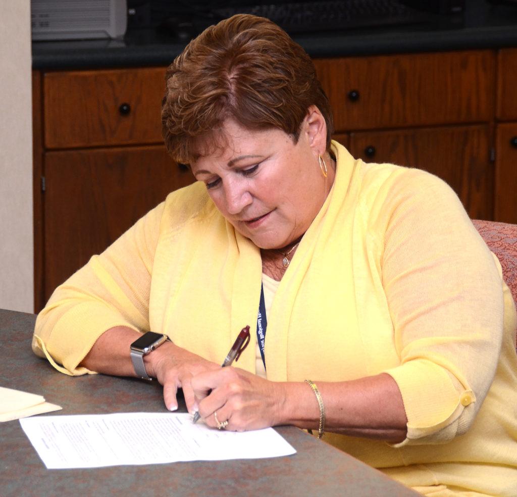 Jane Wheatley, chief executive officer at Taylor Regional Hospital, signs a partnership agreement between TRH and Campbellsville University. (Campbellsville University Photo by Joshua Williams)