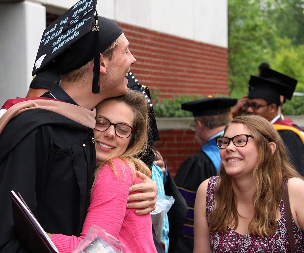 Katy Lewis of North Augusta, S.C. and Katie Miller of Fayetteville, Ga. congratulates Patrick Sonsteng of Campbellsville graduating with his master's degree. (Campbellsville University Photo by Drew Tucker) 