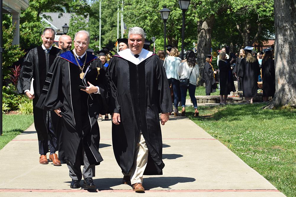 From left: Henry Lee, chairman of Campbellsville University's Board of Trustees, Dr. Michael V. Carter, president, and Max Wise, Kentucky State Senator, 16th Senatorial District, lead the senior walk for the commencement ceremony at Campbellsville University. (Campbellsville University Photo by Kyrsten Hill) 