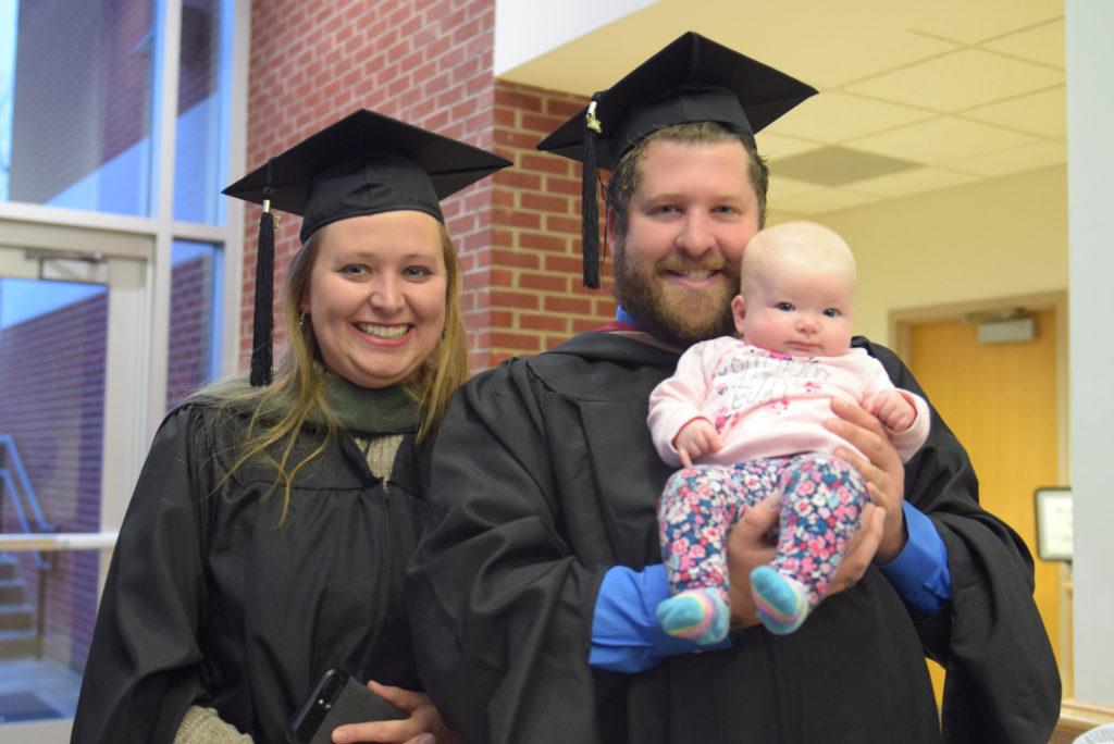 Brandon Lakes, left, resident director of South Hall West, and Hillary Lakes, head coach for cross country, with their daughter, Haily, celebrate after they receive their master's degrees at Campbellsville University. (Campbellsville University photo by Andrea Burnside)