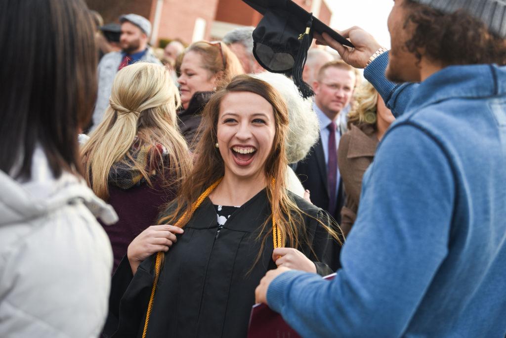 Sarah Stults of Sonora, Ky. laughs after her commencement Friday, Dec. 15 from Campbellsville University. She received a bachelor of science in psychology graduating magna cum laude. (Campbellsville University Photo by Joshua Williams)